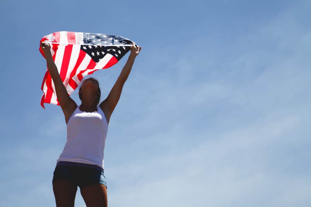 Queens girl raising the American flag