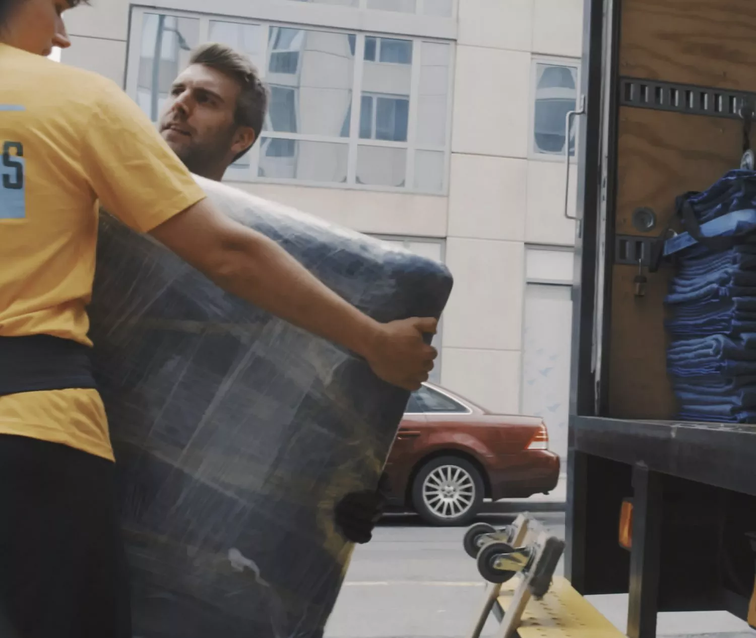 NYC movers loading TV into truck in Manhattan