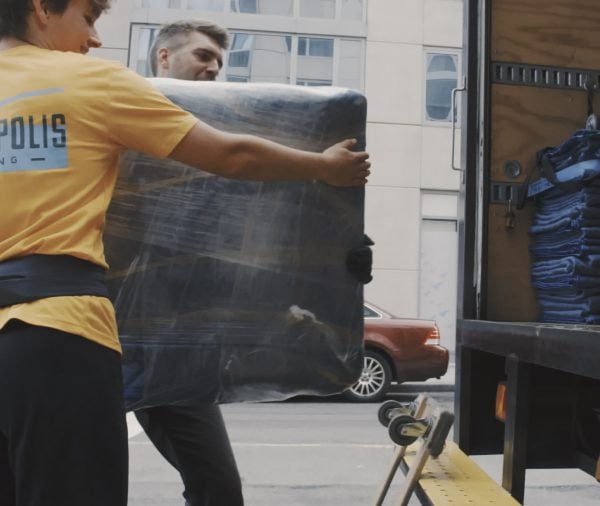 NYC movers loading TV into truck in Manhattan
