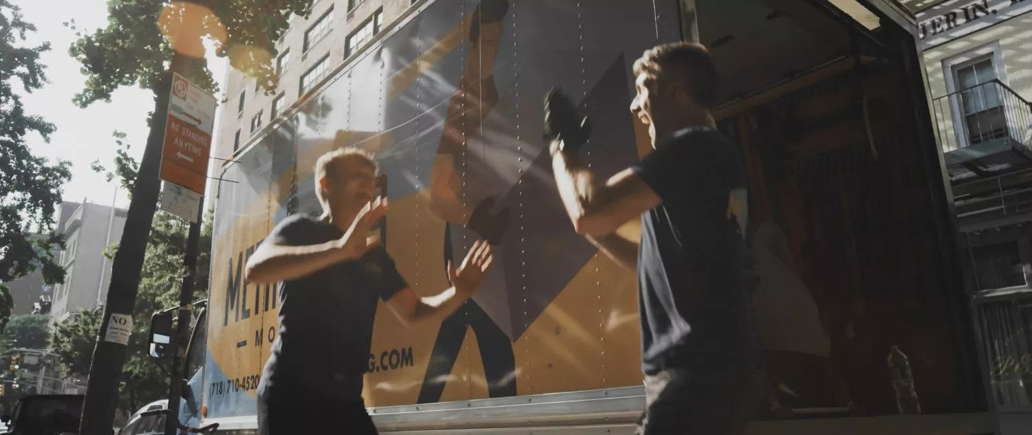 Friendly NYC movers high five