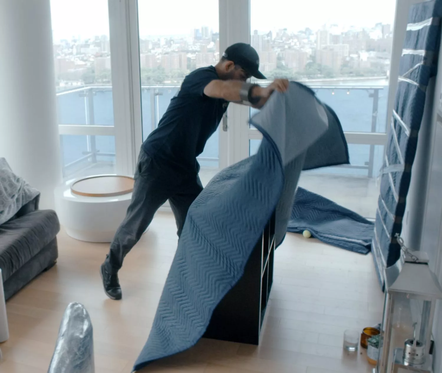 Manhattan movers wrapping furniture in padded blanket