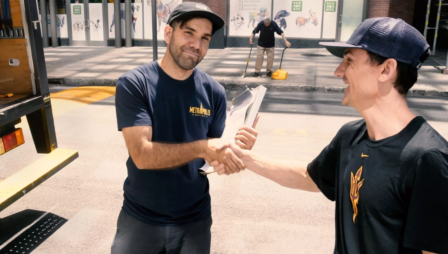 Happy NYC moving customer shaking hands with a mover