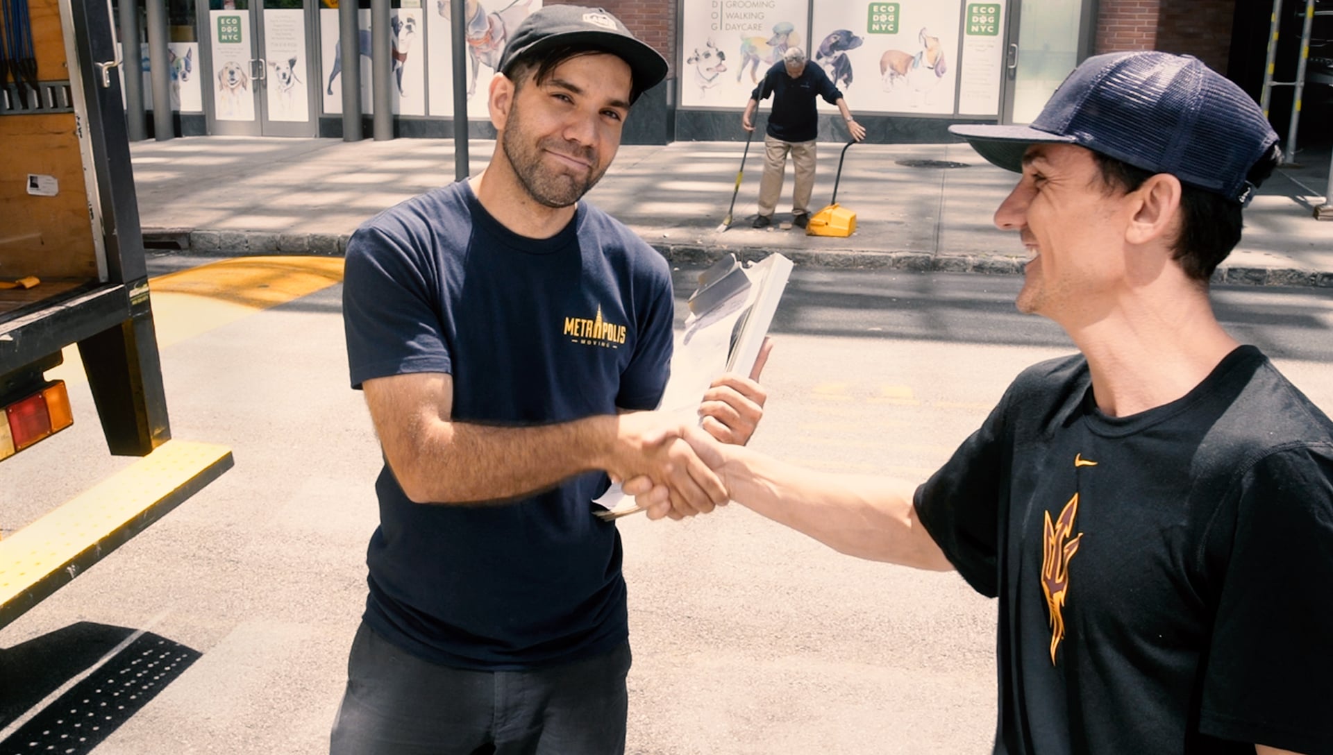 Happy NYC moving customer shaking hands with a mover