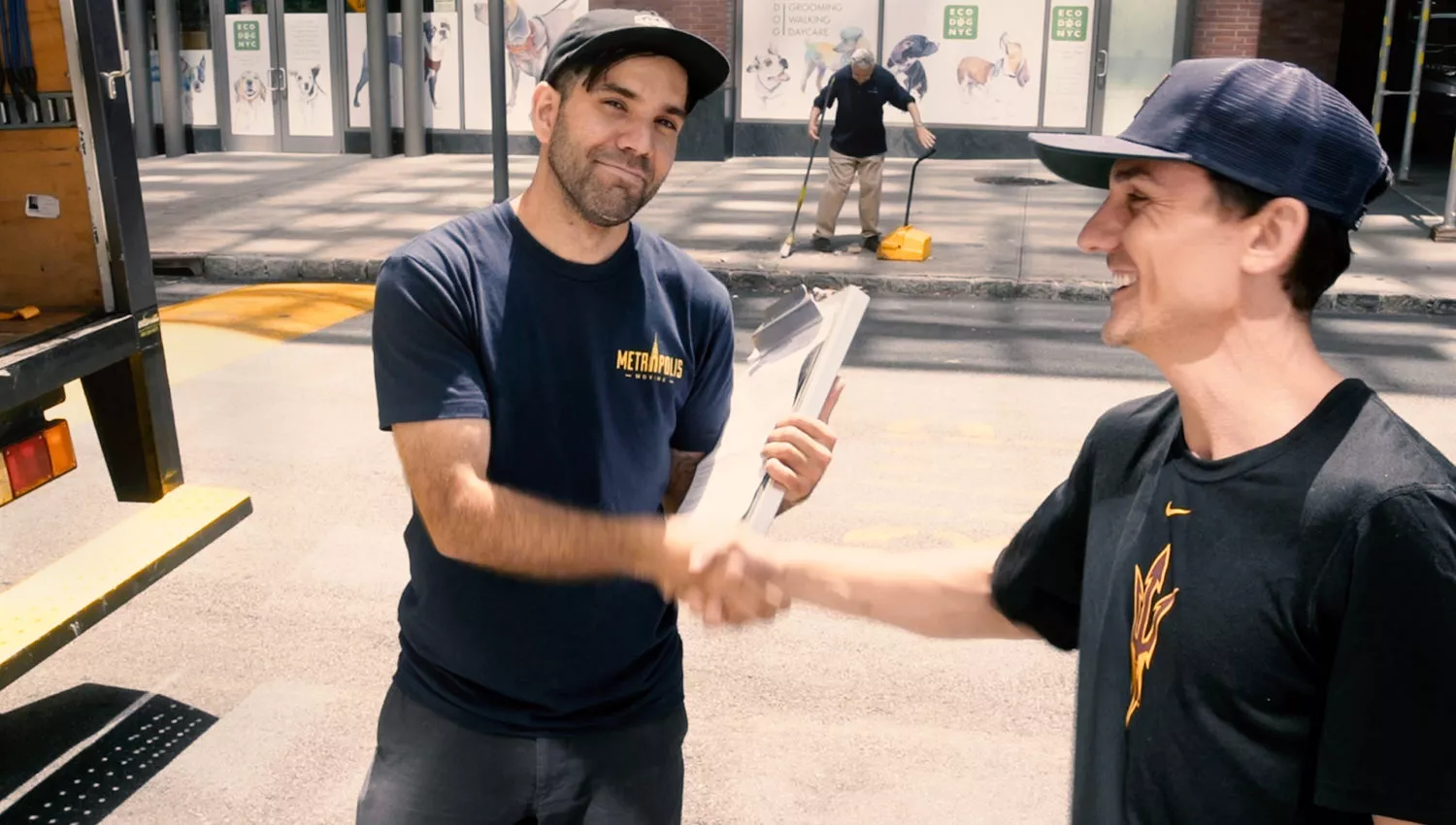 Happy NYC moving customer shaking hands with a mover