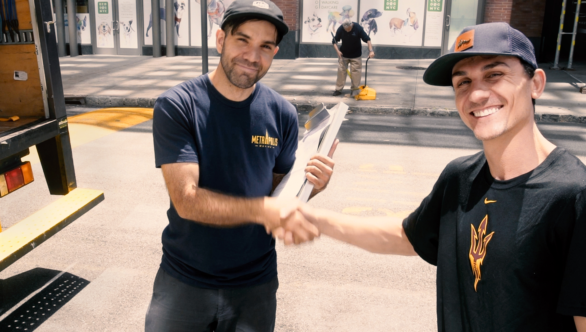 Happy NYC moving customer shaking hands with a mover