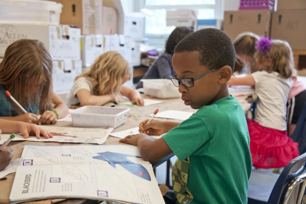 child doing school work at his desk