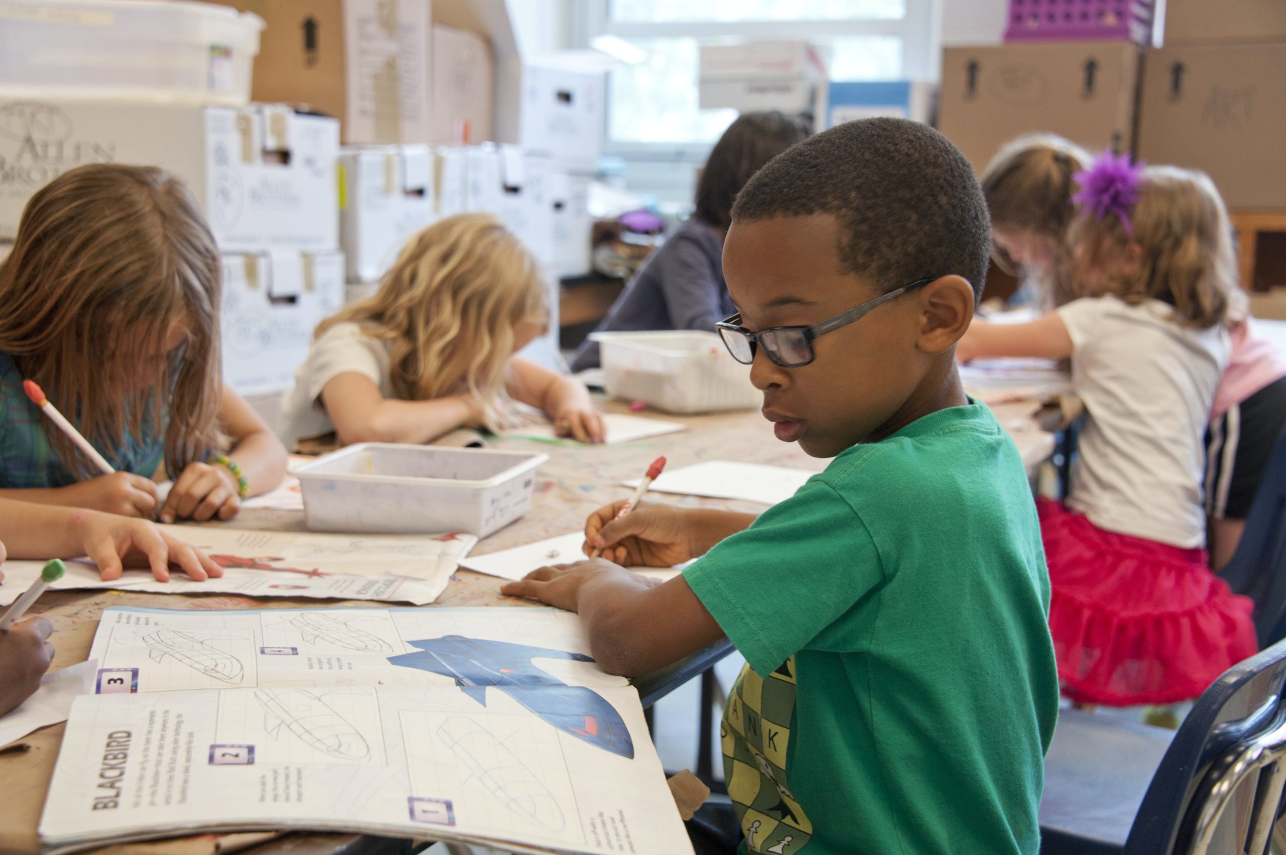 child doing school work at his desk