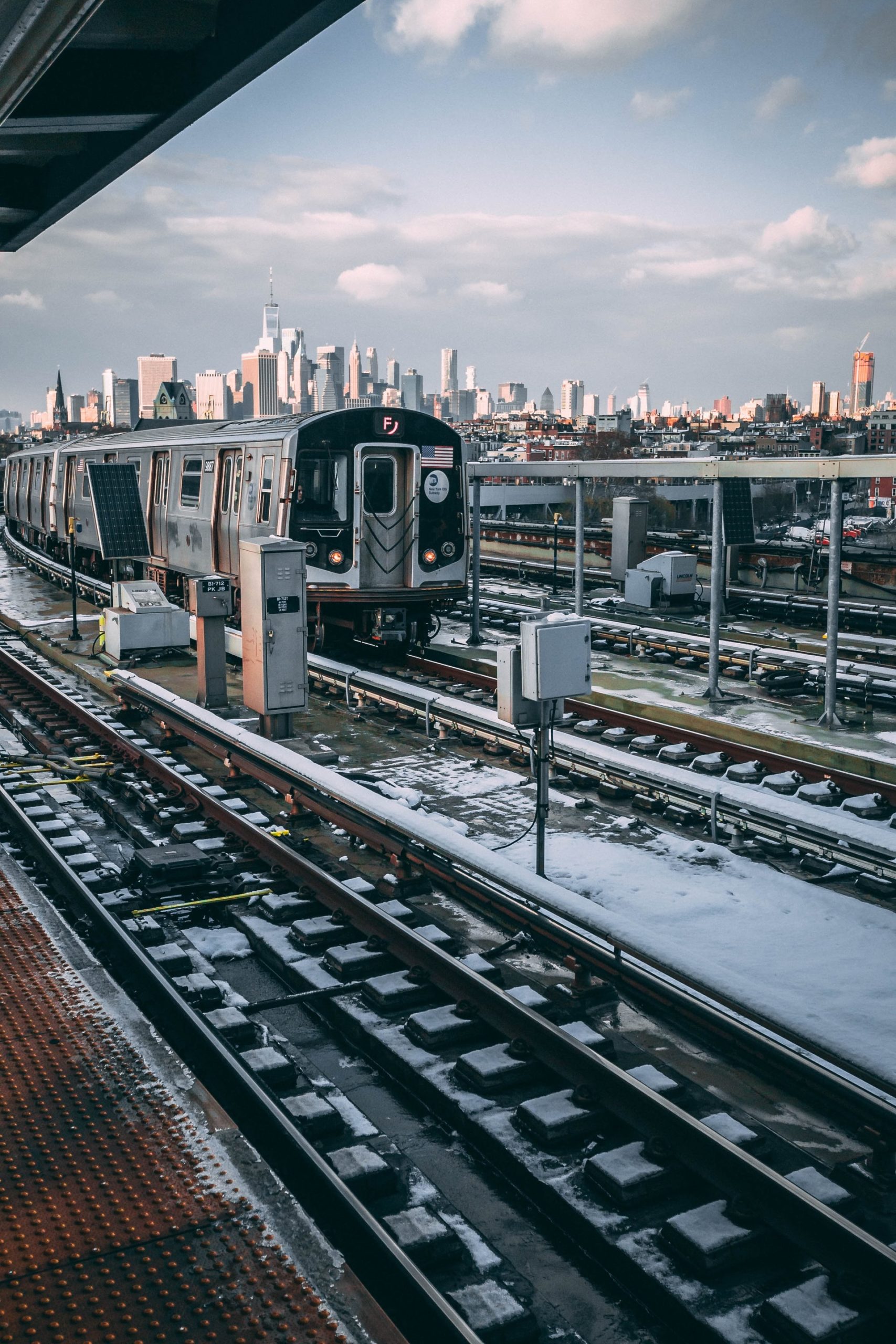 nyc subway with skyline in the background