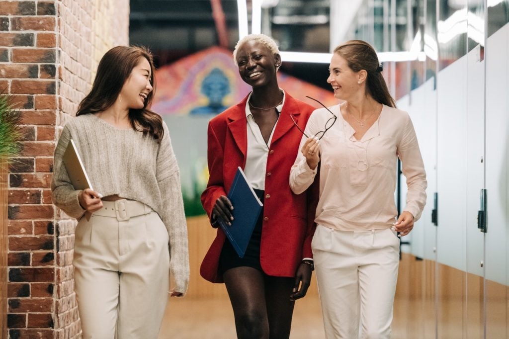 workers dressed in business casual in conversation at an office