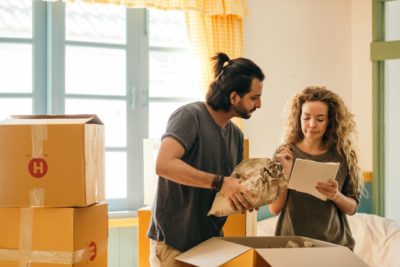 man and woman demonstrate how to pack china for a move