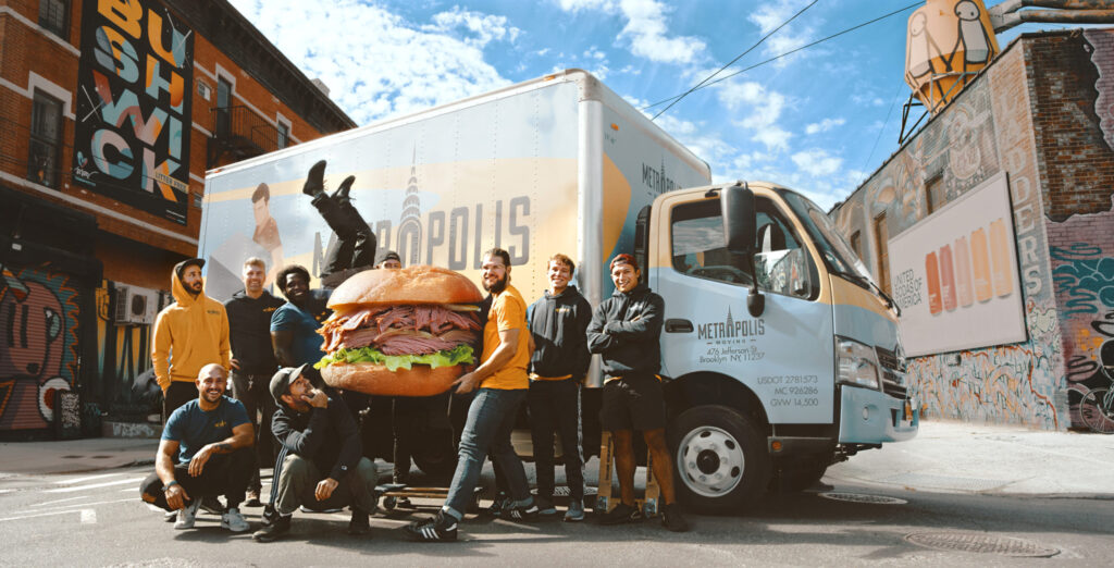 New York City movers with a pastrami sandwich